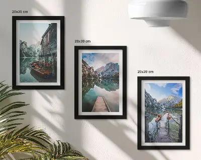 A quiet lake in the mountains with wooden boats framed triptych