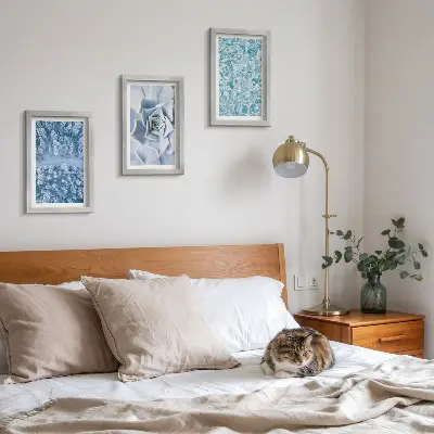 Photo frame wall with winter forest, blue flowers, and water surface print