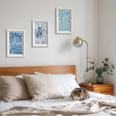 Photo frame wall with winter forest, blue flowers, and water surface print