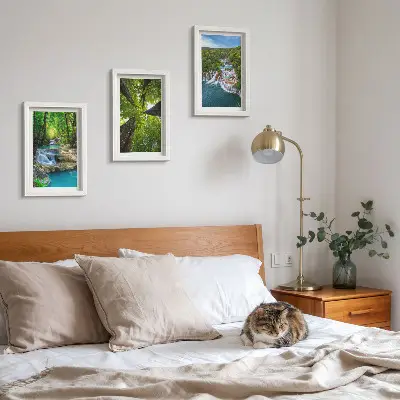 Photo frame wall featuring a green forest waterfall landscape with crystal clear water