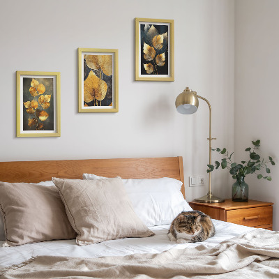 Framed triptych Leaves in shades of yellow on a dark background