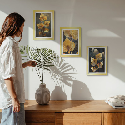 Framed triptych Leaves in shades of yellow on a dark background