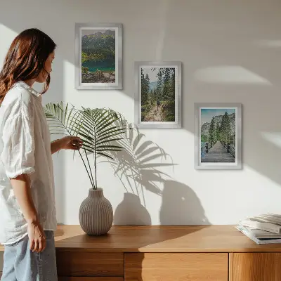 Photo frame wall featuring nature landscapes of mountains lakes forests and paths