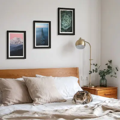 Framed triptych mountains with a pink sky, water, and green succulents