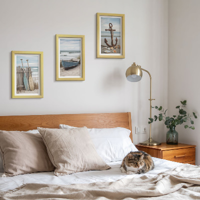 Photo frame wall A beach with a rowboat and an anchor in the sand