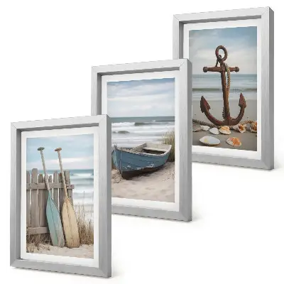 Photo frame wall a beach scene with a rowboat and an anchor in the sand