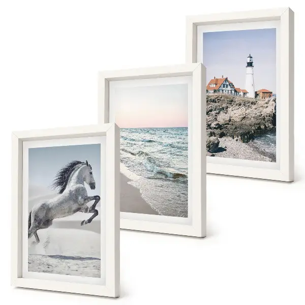 Photo frame wall featuring horses in motion on a beach with a lighthouse and water waves