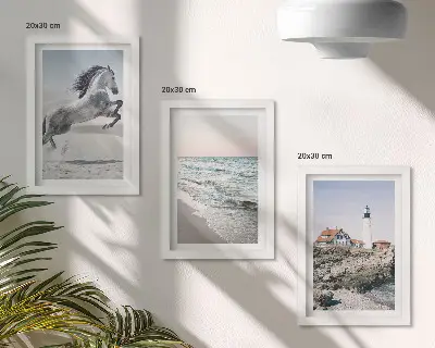 Photo frame wall featuring horses in motion on a beach with a lighthouse and water waves