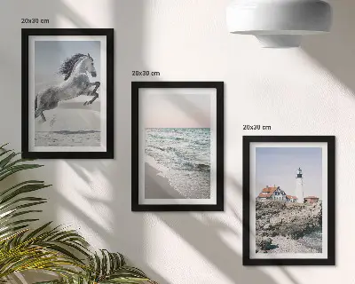 Photo frame wall featuring horses in motion on a beach with a lighthouse and water waves