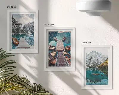 A lake with wooden piers and mountains framed triptych
