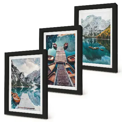 A lake with wooden piers and mountains framed triptych