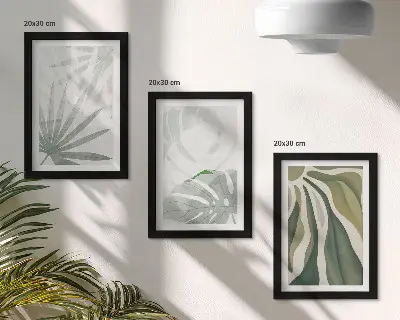Photo frame wall with green and gray plant leaves