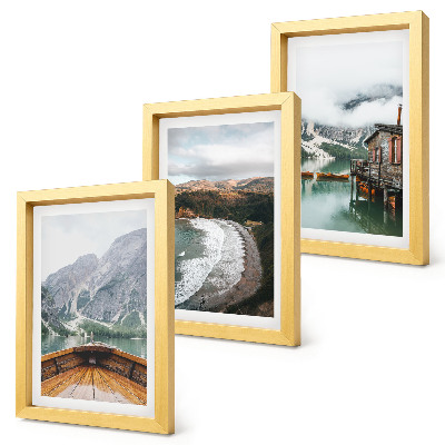 Framed triptych View of the mountains over the lake with a boat and a beach landscape