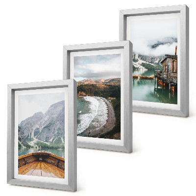 Framed triptych View of the mountains over the lake with a boat and a beach landscape