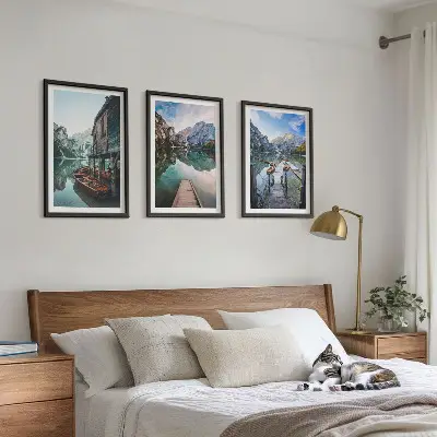 Three-piece wall art set featuring a lake with mountains and wooden boats