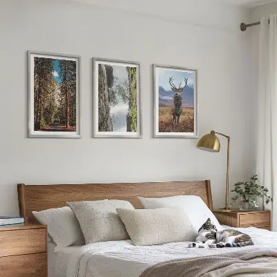 Set of 3 framed wall art pieces featuring a road through a forest with mountains and deer