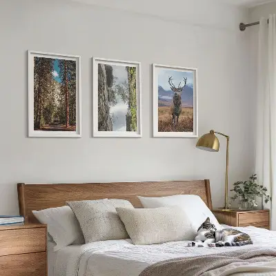 Set of 3 framed wall art pieces featuring a road through a forest with mountains and deer