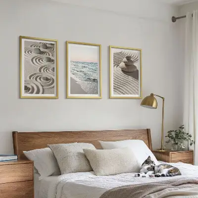Set of 3 framed wall art pieces featuring waves, sand, water, and beach stones