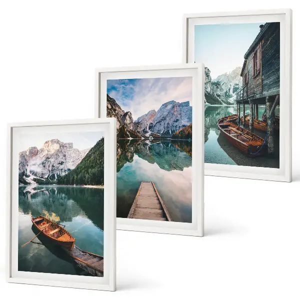 Set of 3 framed wall art pieces featuring a lake with mountains, boats, and a cottage