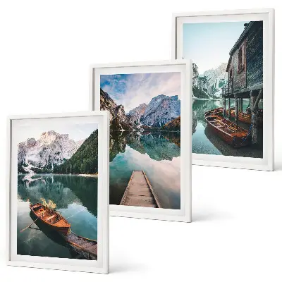 Set of 3 framed wall art pieces featuring a lake with mountains, boats, and a cottage