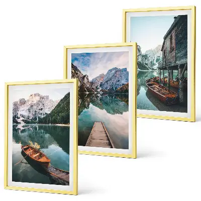 Set of 3 framed wall art pieces featuring a lake with mountains, boats, and a cottage