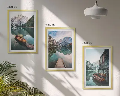 Set of 3 framed wall art pieces featuring a lake with mountains, boats, and a cottage