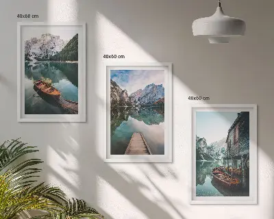 Set of 3 framed wall art pieces featuring a lake with mountains, boats, and a cottage