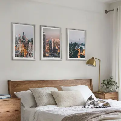 Set of 3 framed wall art pieces featuring city skyscrapers at night with lights