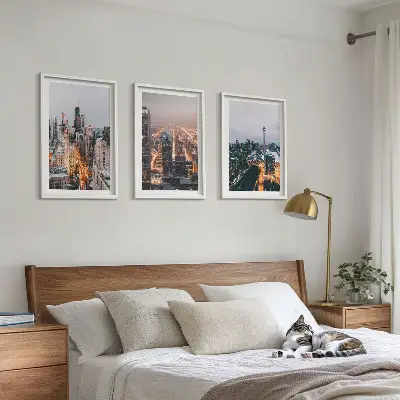 Set of 3 framed wall art pieces featuring city skyscrapers at night with lights