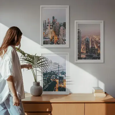 Set of 3 framed wall art pieces featuring city skyscrapers at night with lights