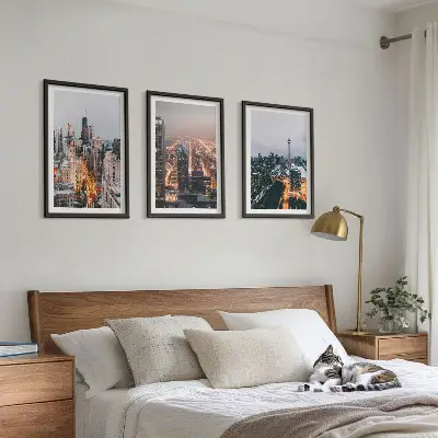 Set of 3 framed wall art pieces featuring city skyscrapers at night with lights