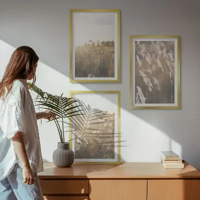 Set of 3 framed landscape wall art pieces featuring grass and flowers with a warm aesthetic