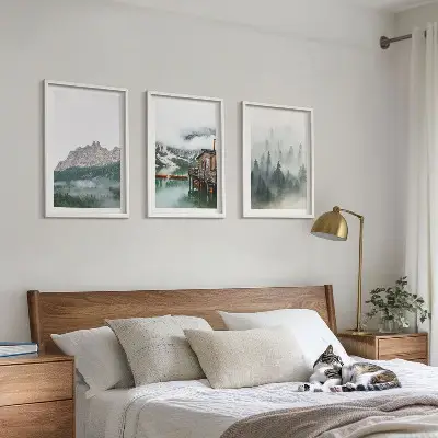 Set of 3 framed wall art pieces featuring mountains, a lake, a cottage, and fog