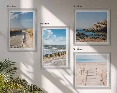 Multi-piece wall decor set featuring a coastal beach scene with sand waves sky and birds