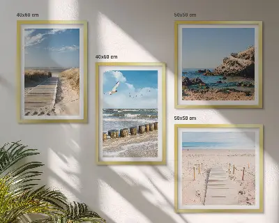 Multi-piece wall decor set featuring a coastal beach scene with sand waves sky and birds