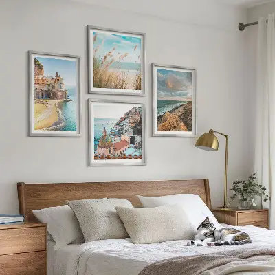 Set of 4 wall art pieces featuring landscape scenes of beaches, cities, and cliffs