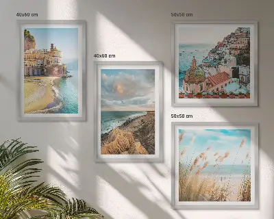 Set of 4 wall art pieces featuring landscape scenes of beaches, cities, and cliffs
