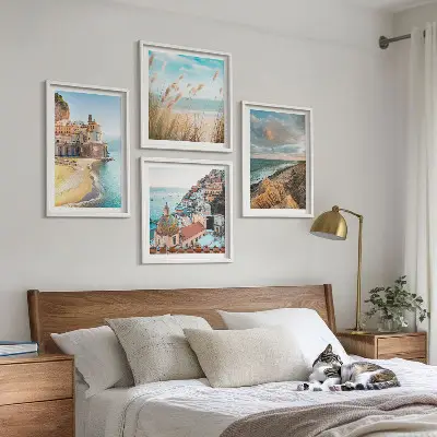 Set of 4 wall art pieces featuring landscape scenes of beaches, cities, and cliffs
