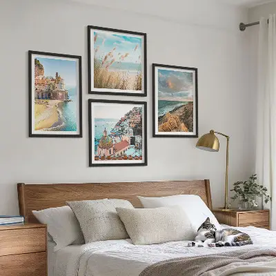 Set of 4 wall art pieces featuring landscape scenes of beaches, cities, and cliffs
