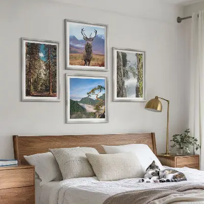 Set of 4 wall art pieces featuring a road forest mountains and deer nature theme