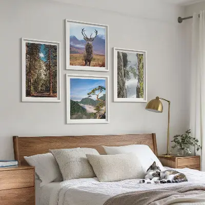 Set of 4 wall art pieces featuring a road forest mountains and deer nature theme