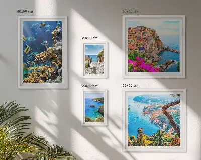 Gallery wall featuring seaside landscapes, fish, and beaches